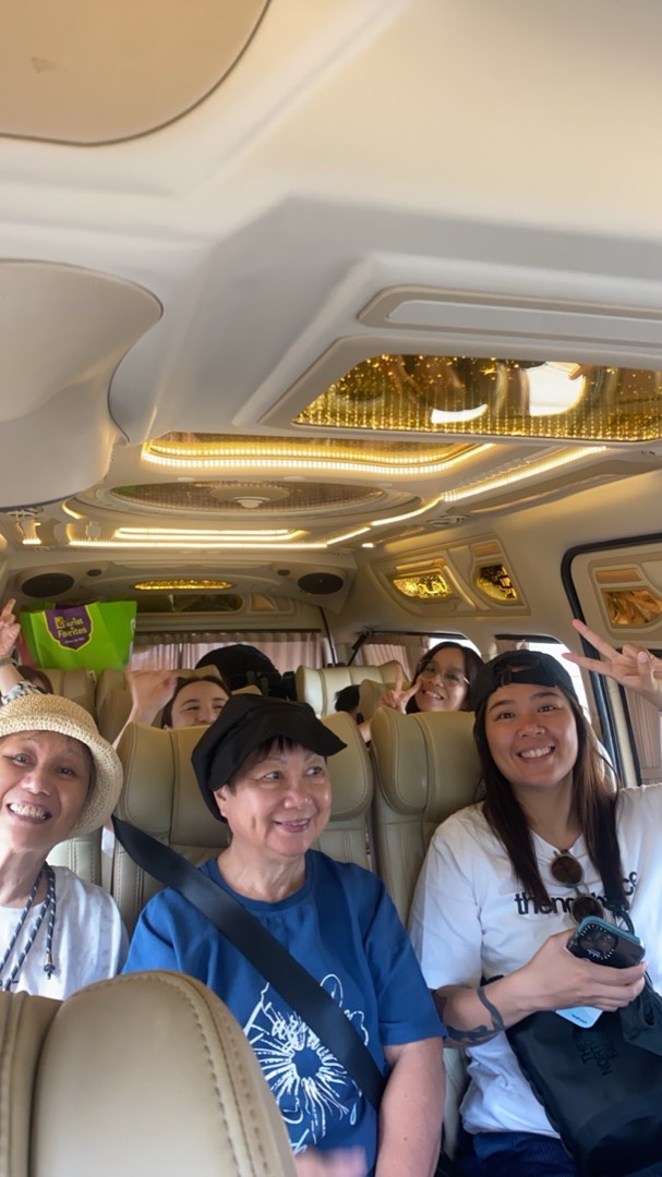 Happy passengers giving peace signs inside Sonny's van